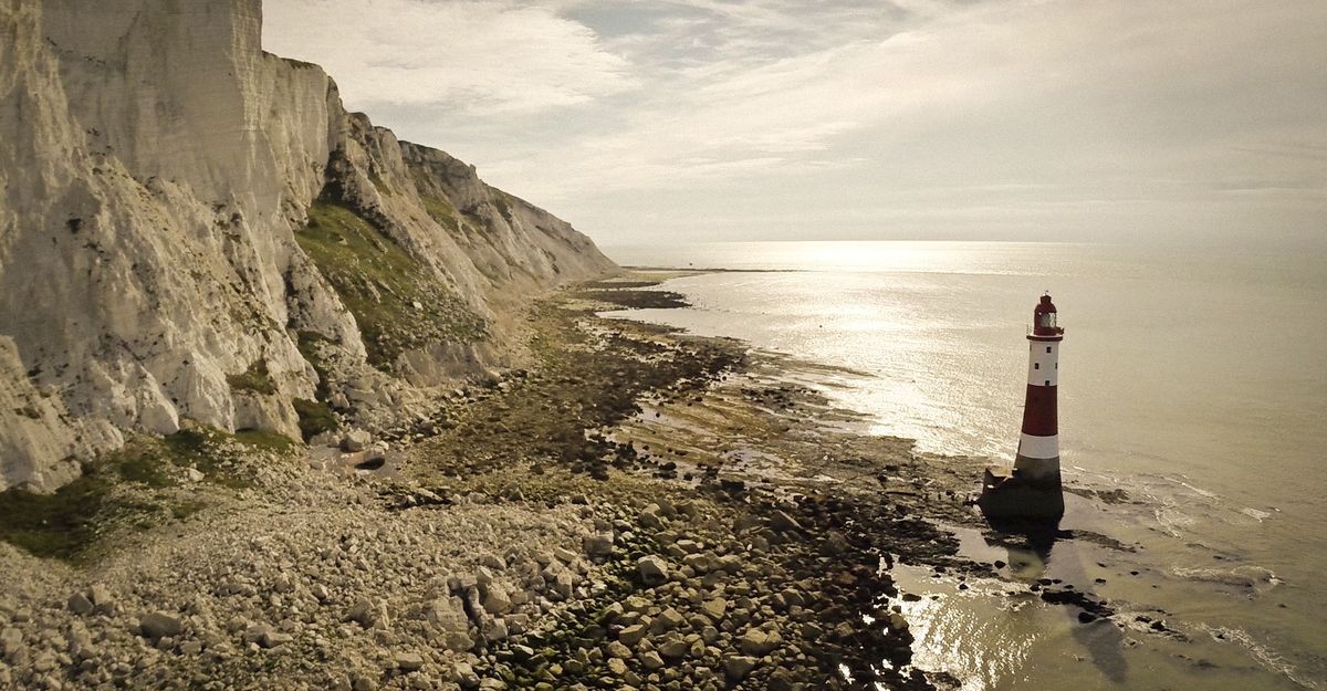 Aerial photograph of Beachy Head lighthouse below the chalk cliffs