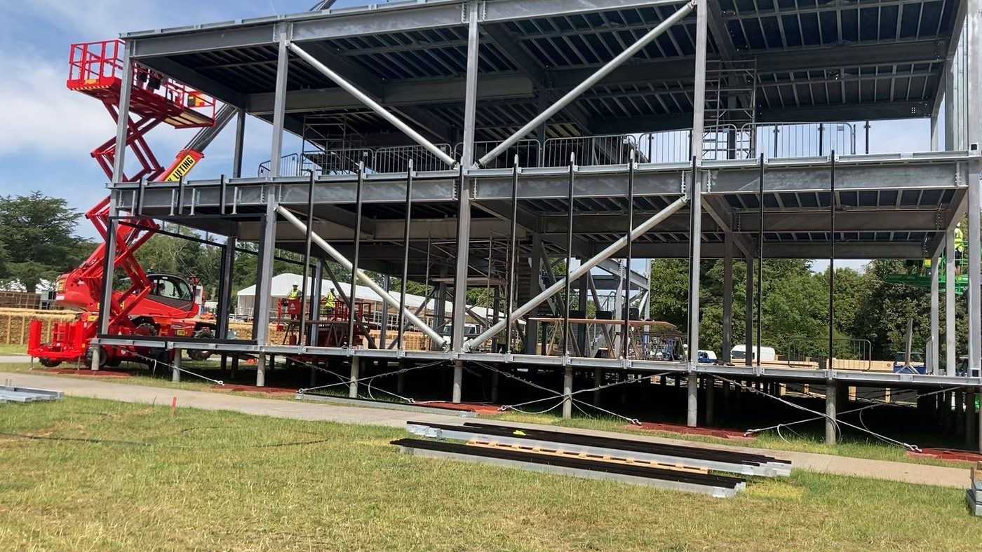 The Bentley pavilion steel frame going up on site at Goodwood, with scissor lifts at each end