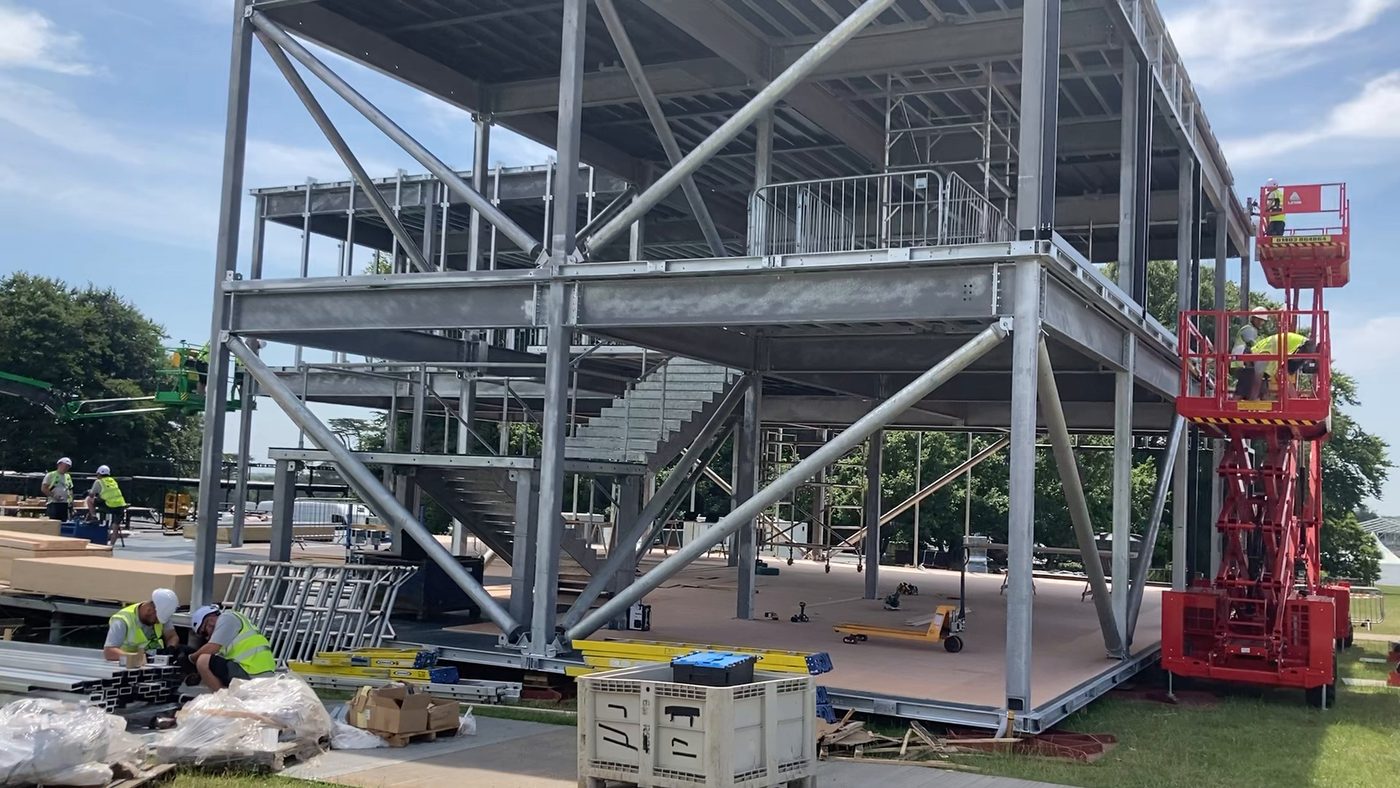 The galvanised steel frame of Bentley's two-storey, 500 m² pavilion under construction at Goodwood Festival of Speed 2025, with the internal staircase in place
