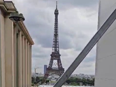 The Eiffel Tower seen past the steel bracing and cladding of the temporary broadcast studios on the Trocadéro, Paris, in 2024